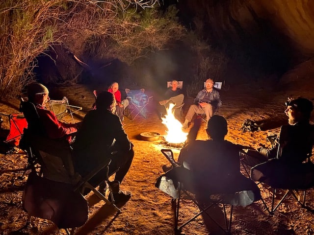 Friends circled around campfire